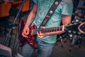 A man playing a guitar in a recording studio